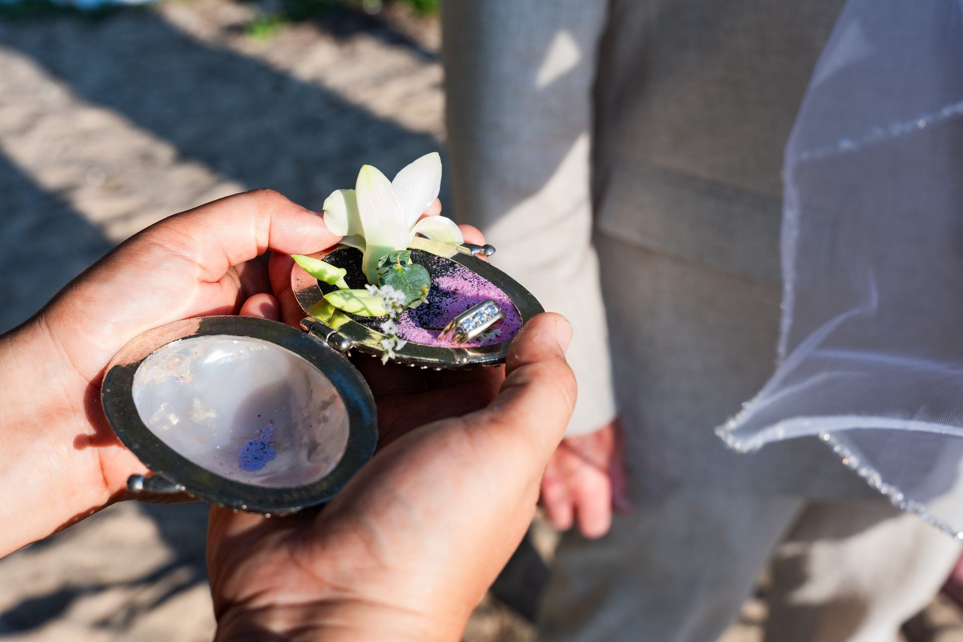 Close-up of a ring being exchanged during a Barefoot beach ceremony Close-up of a ring being exchanged during a Barefoot beach ceremony