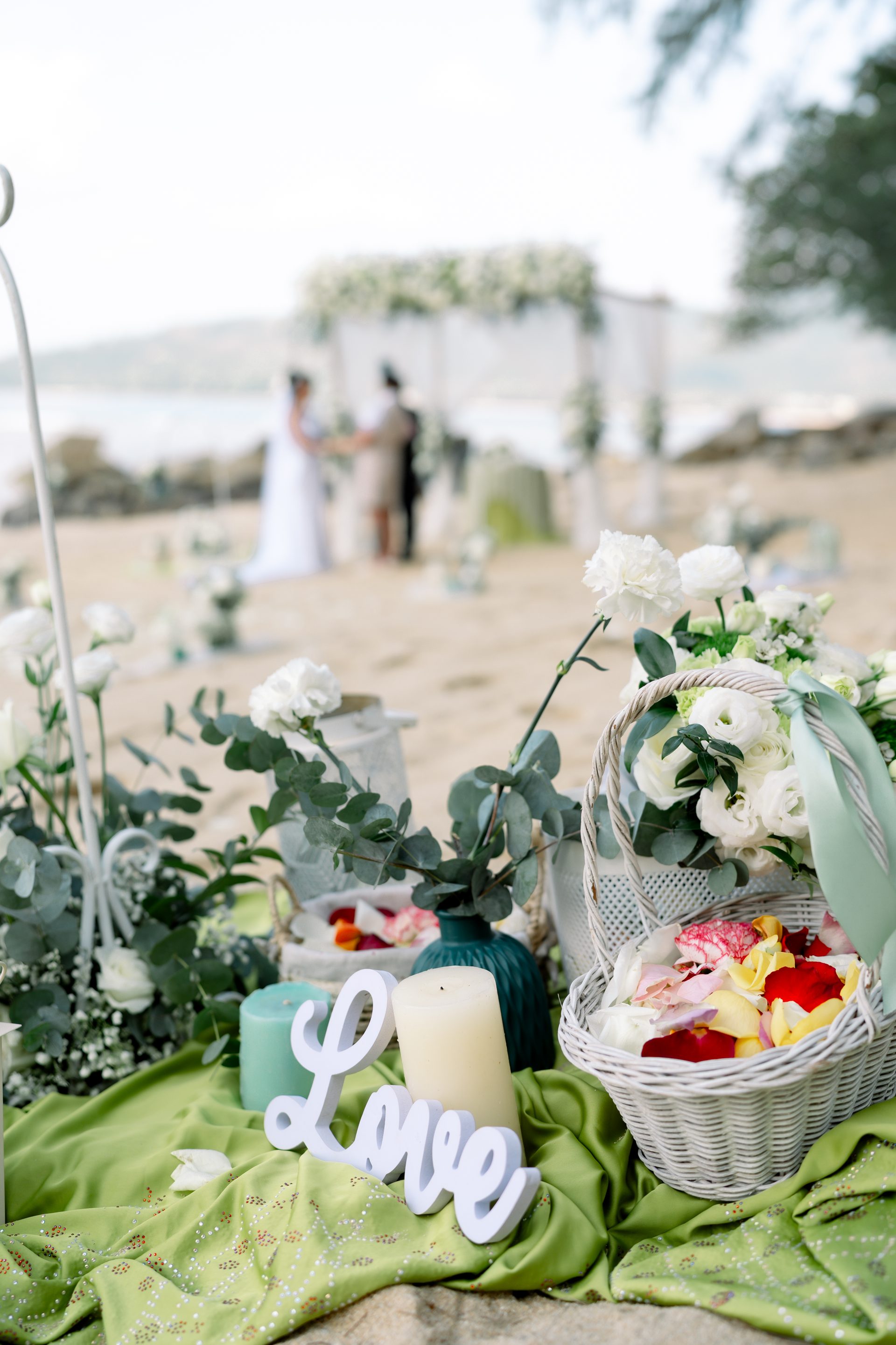 Close details of a Barefoot ceremony basket and signing table styled on the sand